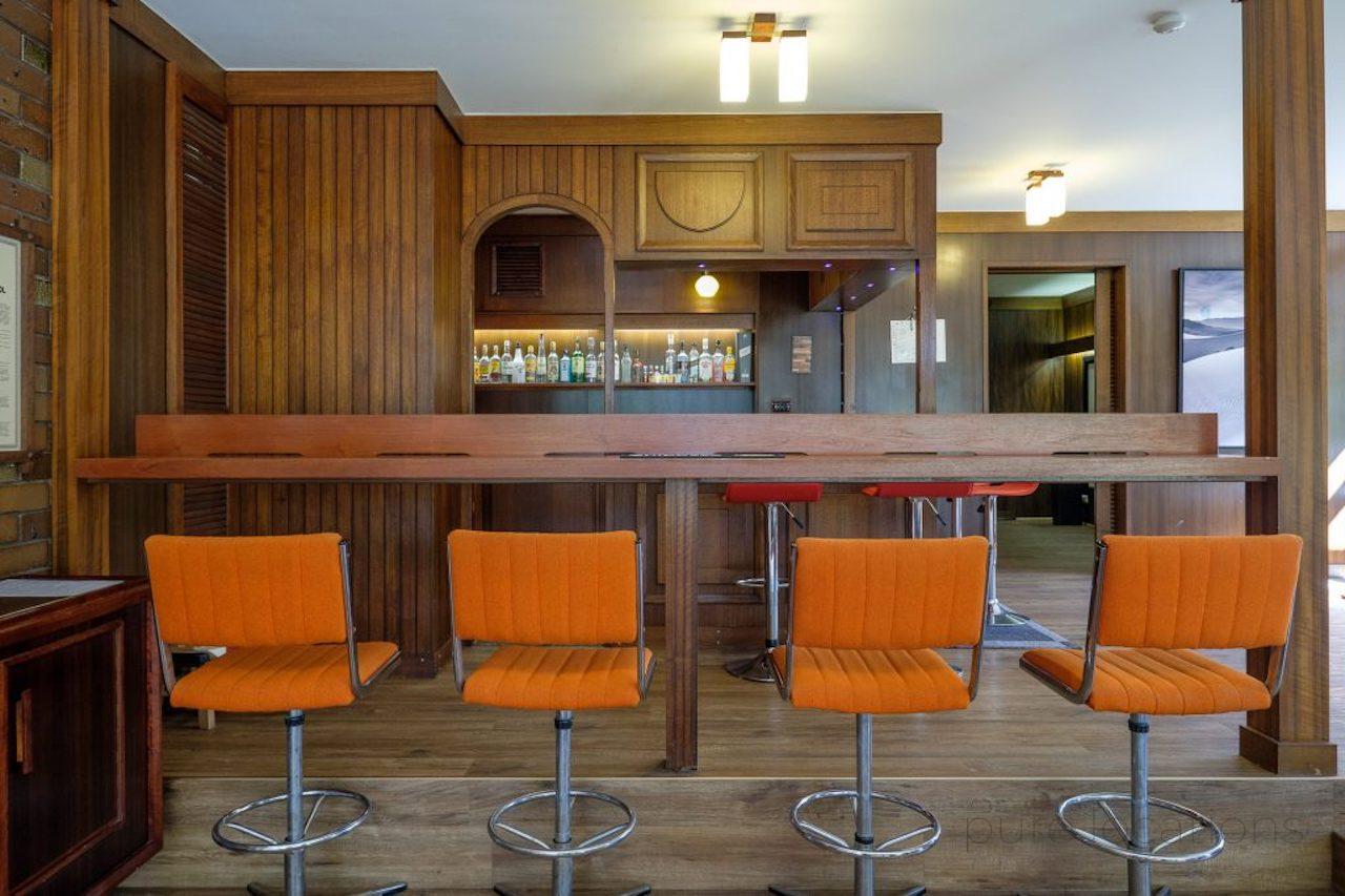 Timber bar for photoshoots, retro bar area for film and TV, orange stools