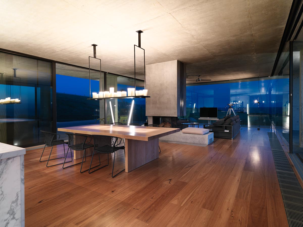Floor to ceiling glass windows, concrete and timber throughout this photoshoot house 
