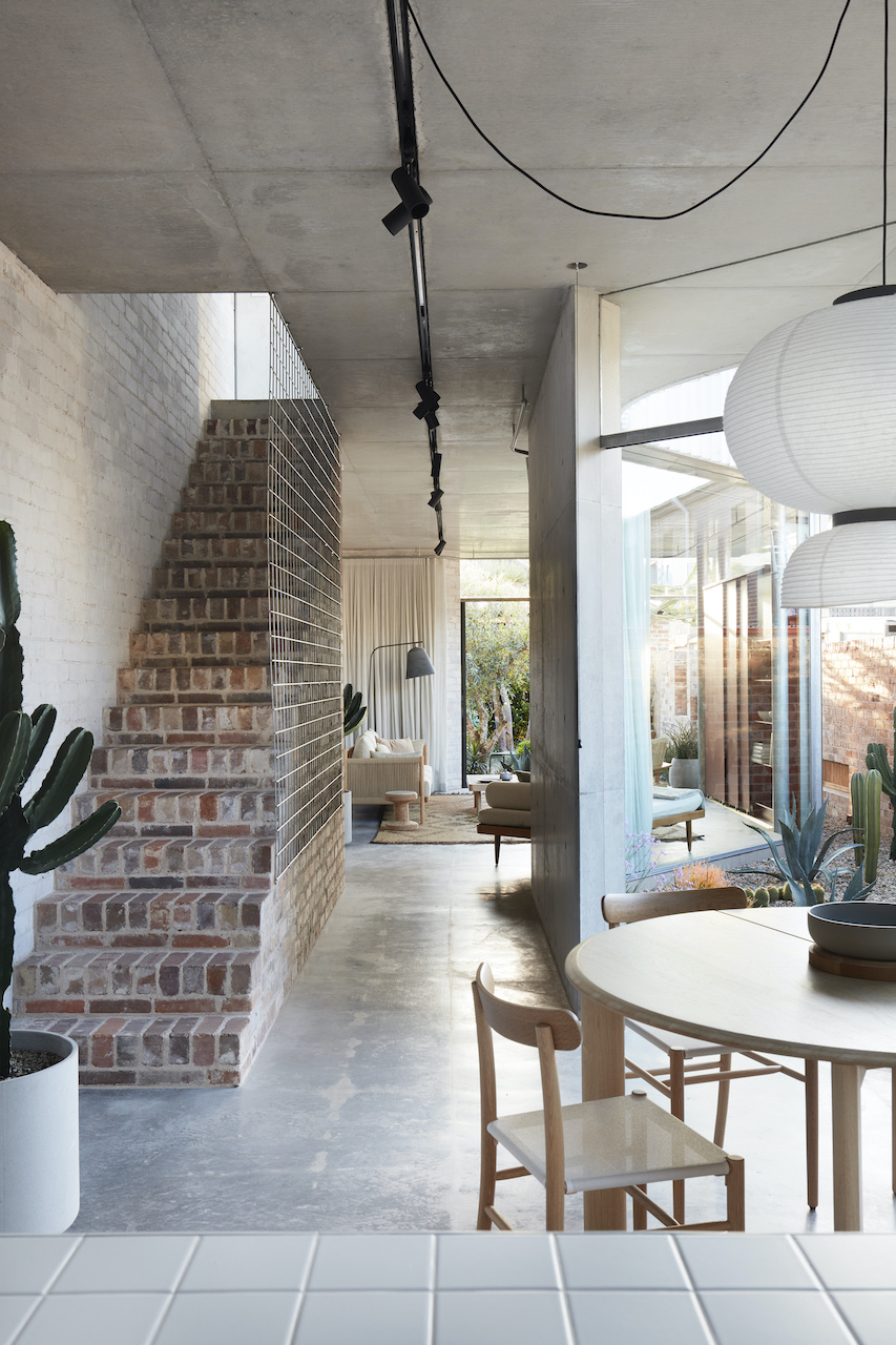exposed brick staircase and concrete floor