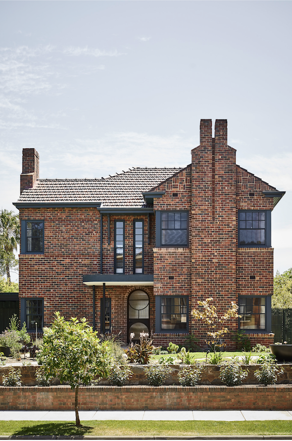 A Melbourne house with brick exterior and black framed windows and door