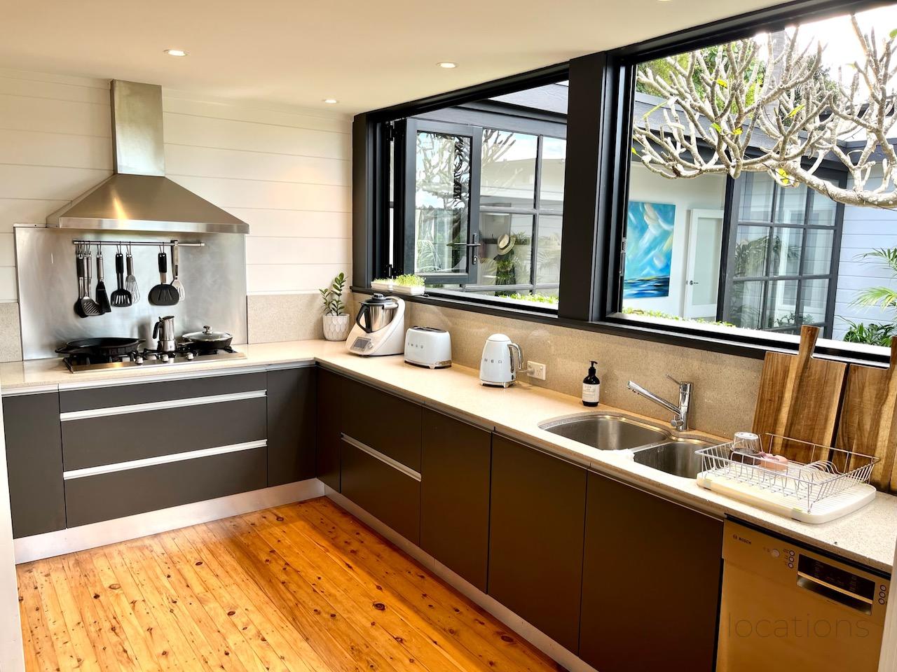 Black kitchen with stainless steel appliances