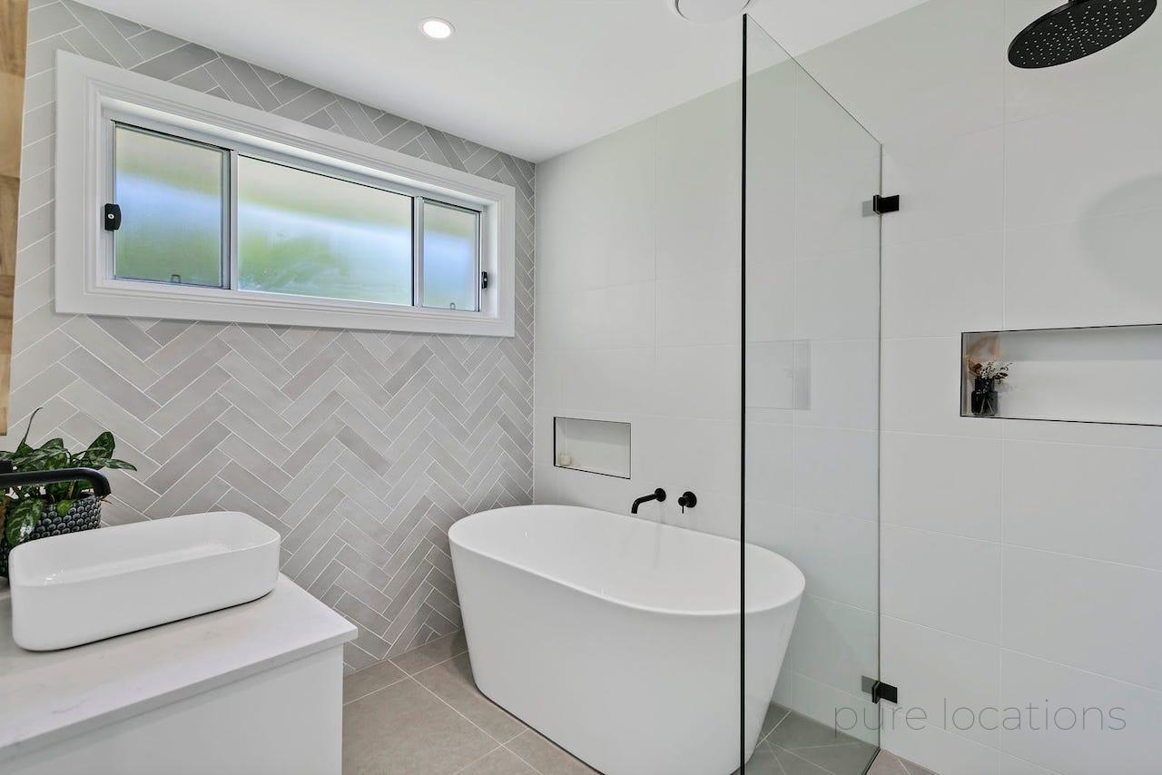 Modern coastal bathroom design, grey subway tiles