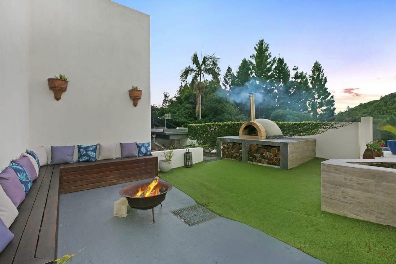 wood fire pizza oven with fire pit and built in seating, mediterranean outdoor location for filming