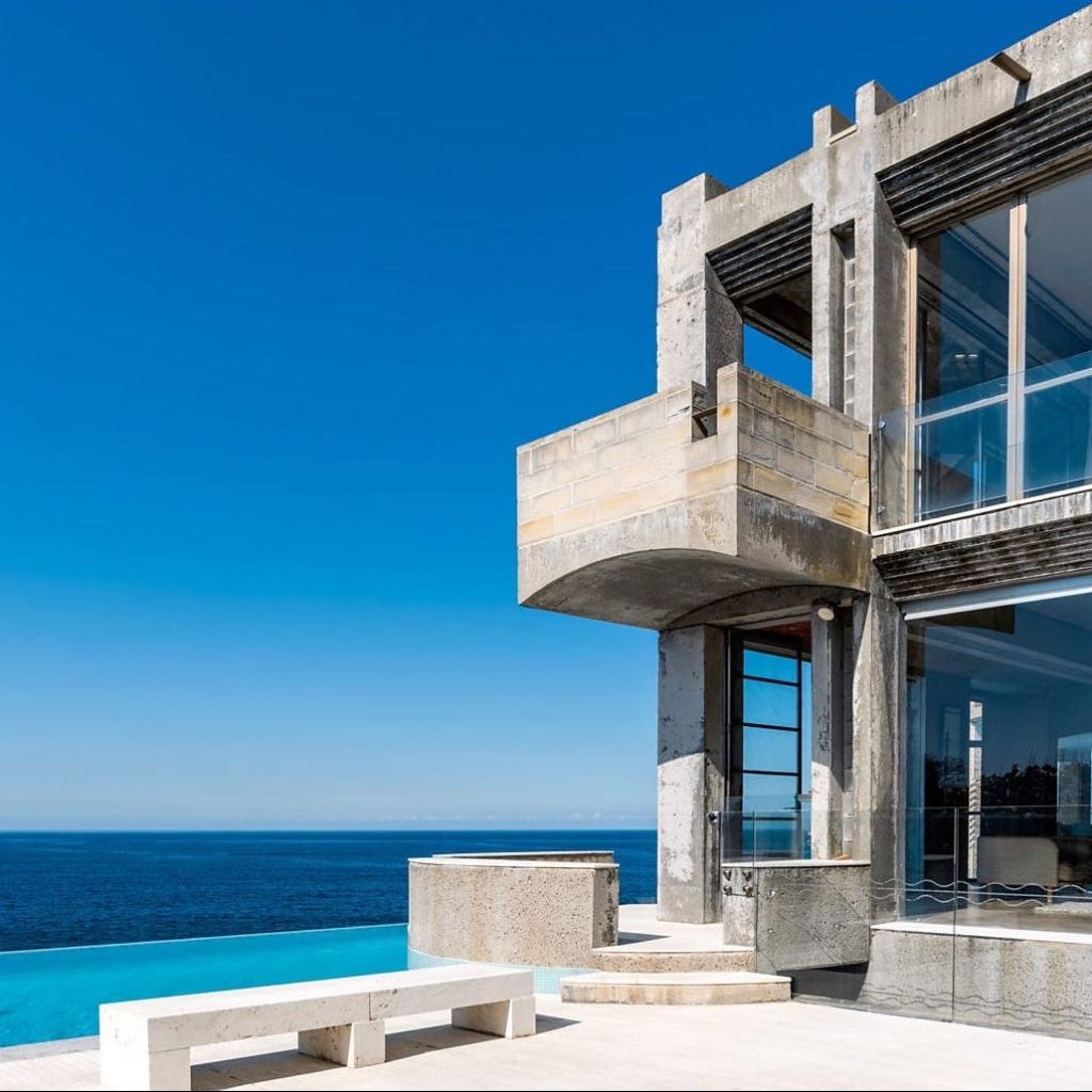 The exterior of a concrete location house in Sydney that looks over the ocean