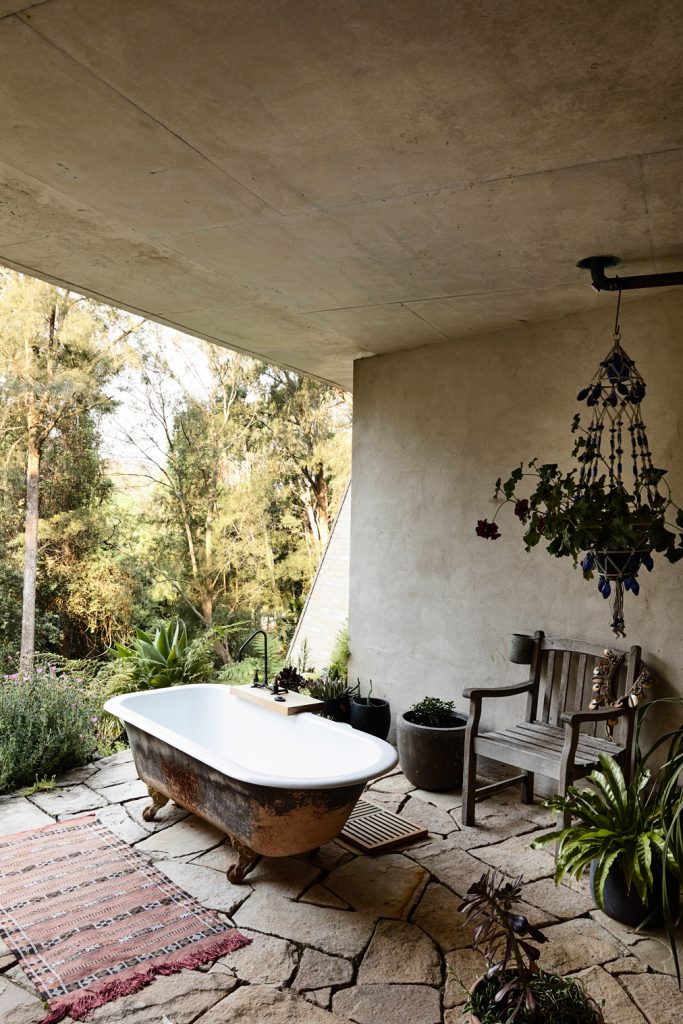 An outdoor bath against a concrete wall in a Sydney location house