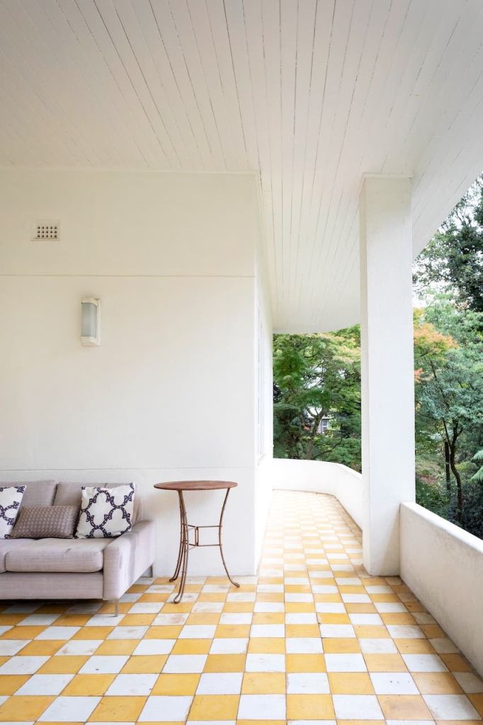 A balcony with yellow checkerboard tiles in a Sydney location house